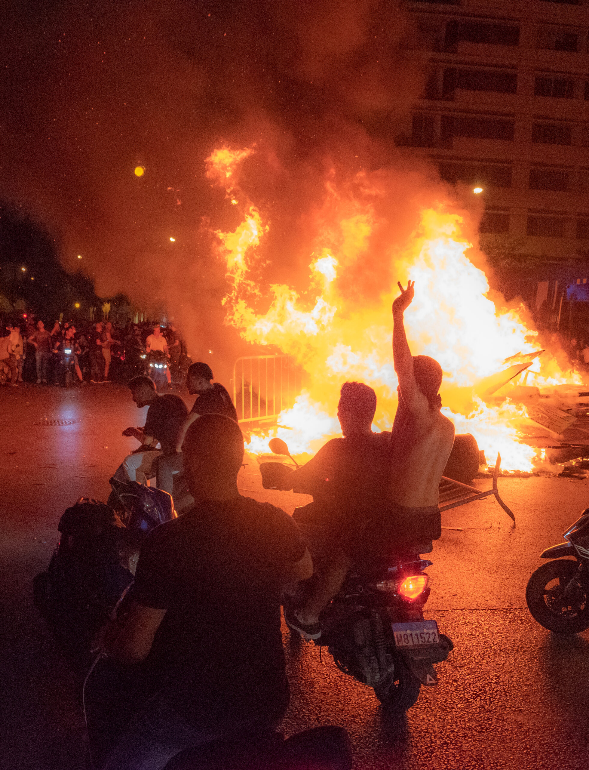 Beeping motorcycles going around the fire pit in Downtown Beirut. 17 October 2019. 